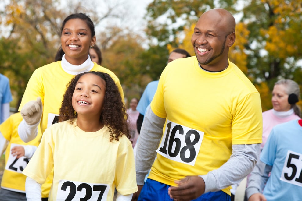 Happy family walking at a charity walk event