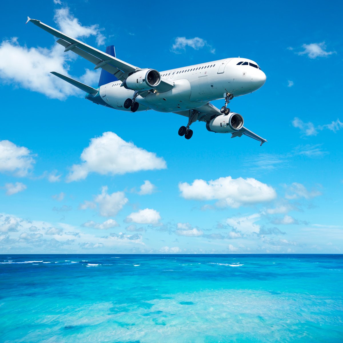 Jet plane flying over clear blue sea